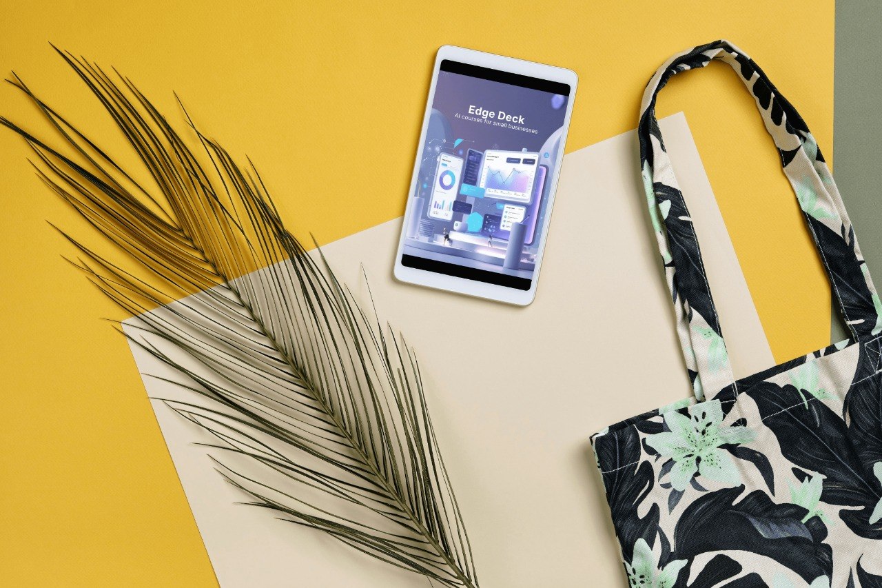 Phone with app on screen, palm leaf, and floral-patterned bag on yellow and beige background